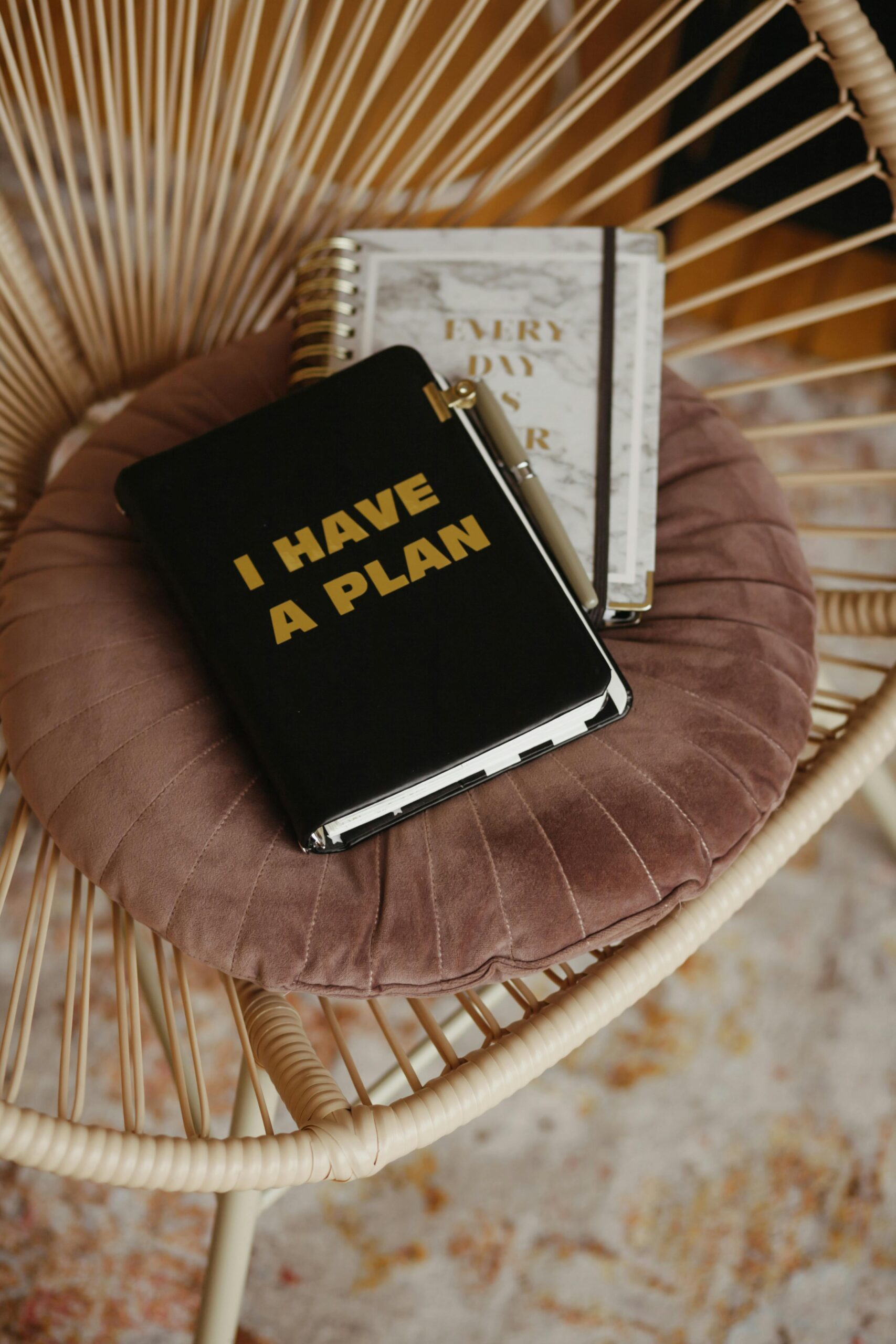 A stylish journal titled 'I Have a Plan' on a plush chair, inspiring organization and productivity.